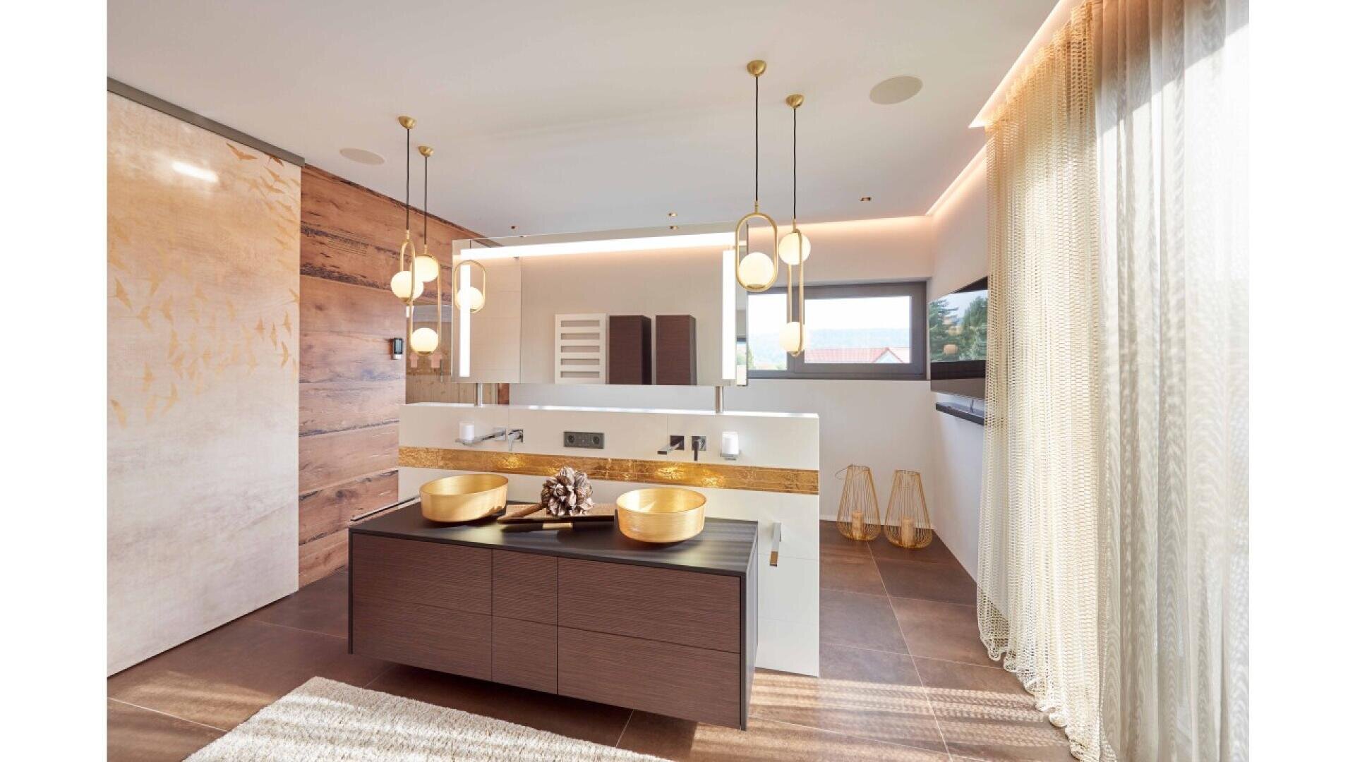 Modern bathroom with a double vanity, gold vessel sinks, pendant lights, wood accents, a large mirror, floor-to-ceiling window with sheer curtains, and a neutral color palette.