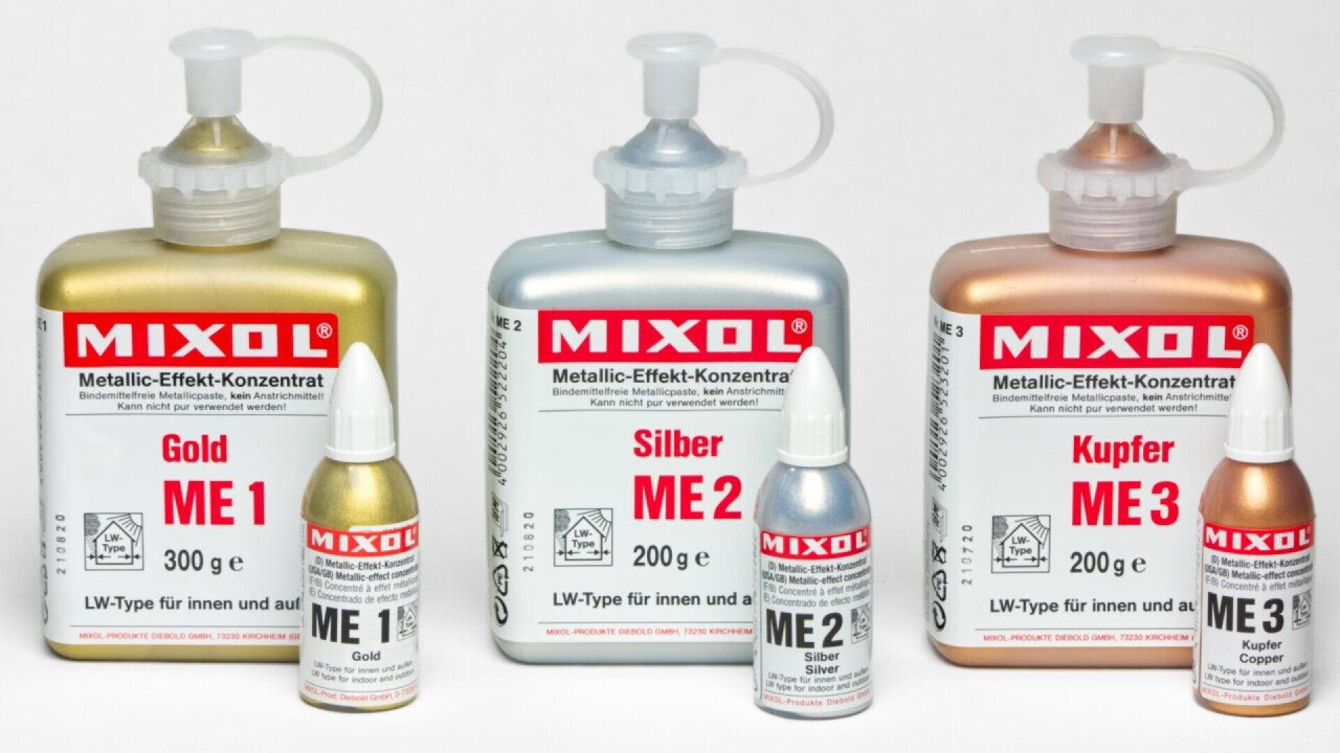 Three bottles of MIXOL metallic effect concentrate in gold (ME1), silver (ME2), and copper (ME3), each with a matching small dropper bottle in front, arranged on a white background.