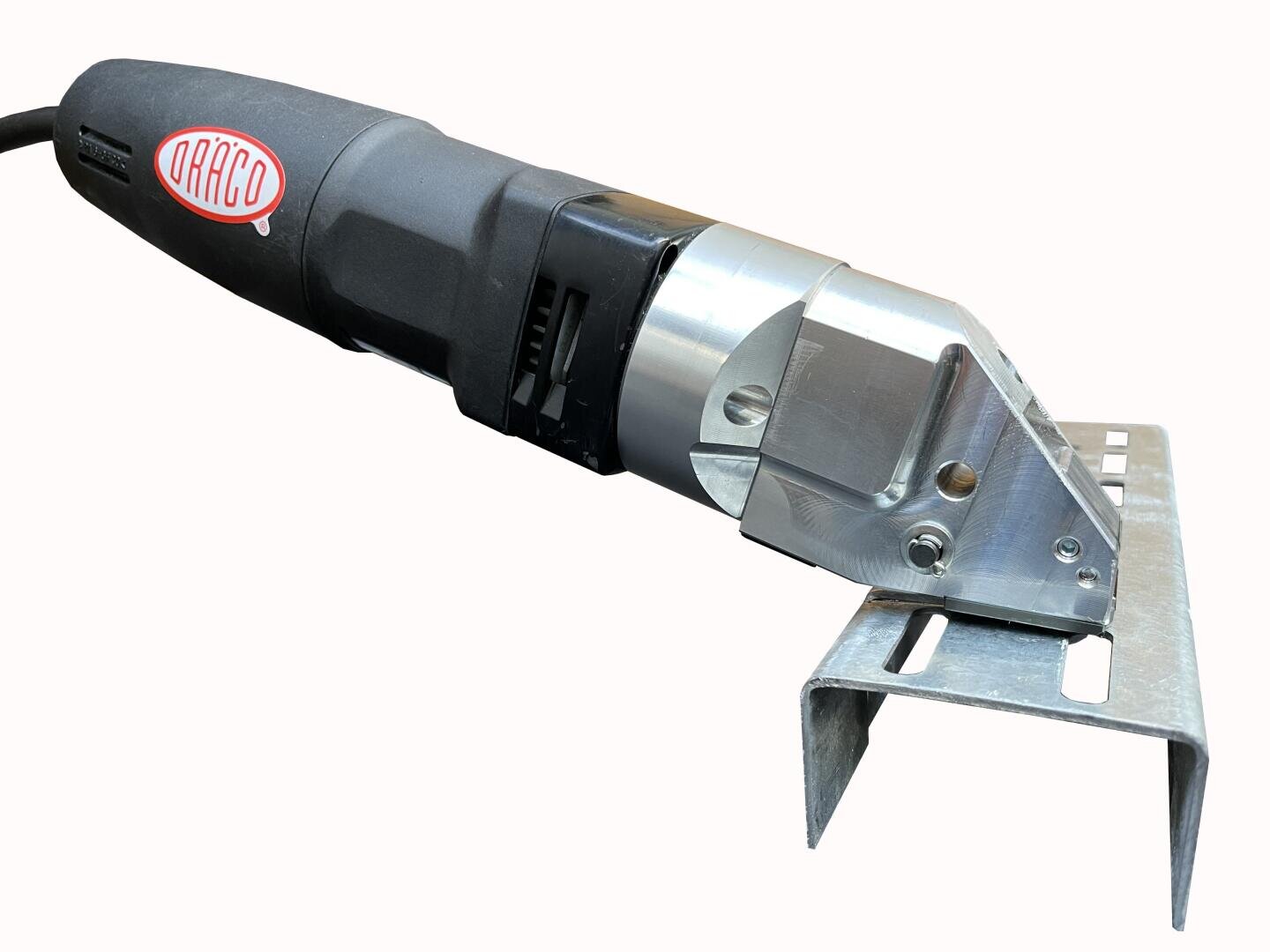 Electric metal cutting tool with a black handle and metallic cutting head, positioned on a U-shaped piece of metal, ready to make a cut. The tool has a red DRÄCO logo on its side.