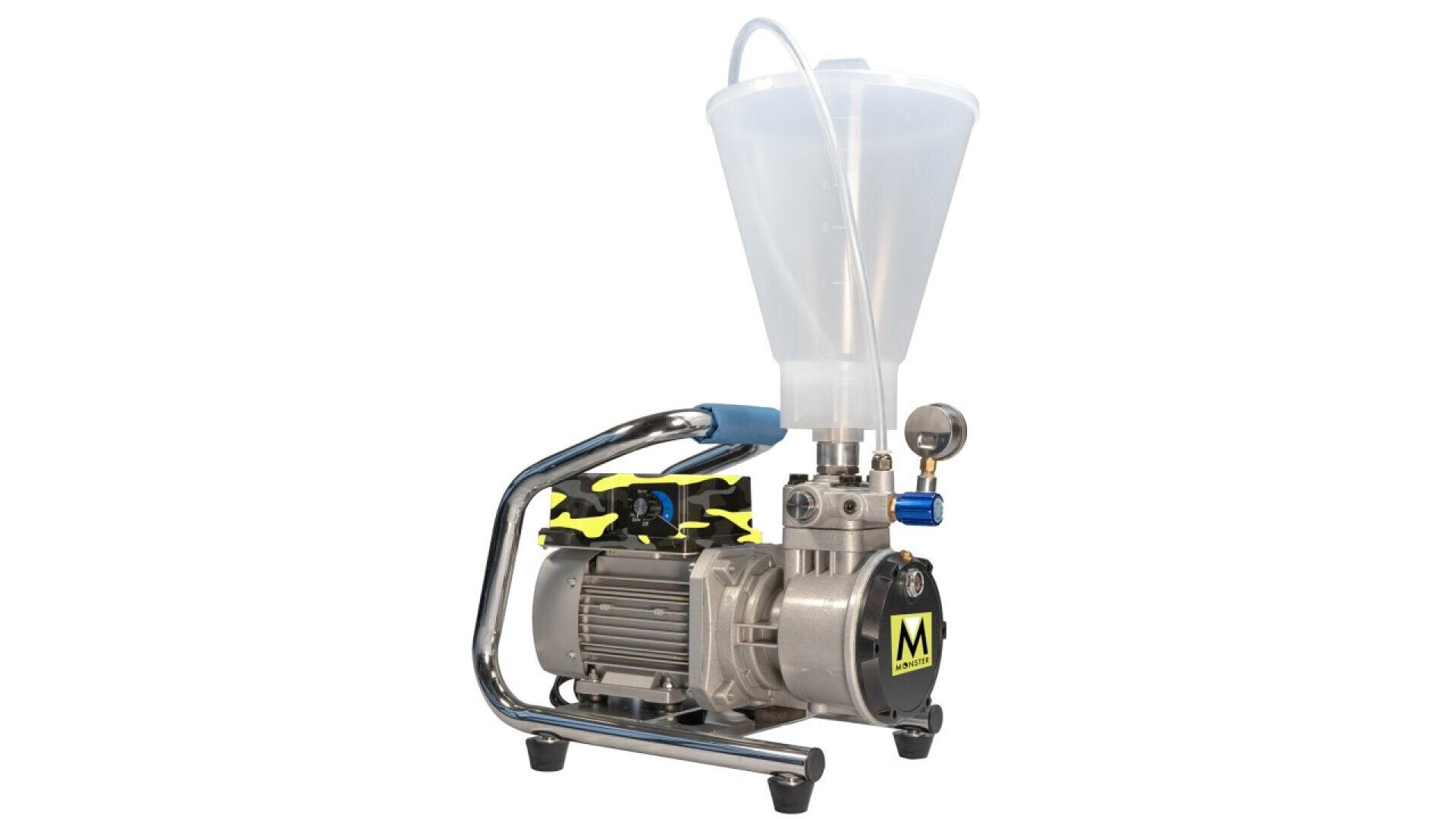 A metallic motorized device with a handle, pressure gauge, and a large, transparent funnel attached on top, resting on short legs. The motor has a label with a yellow M on a black background.