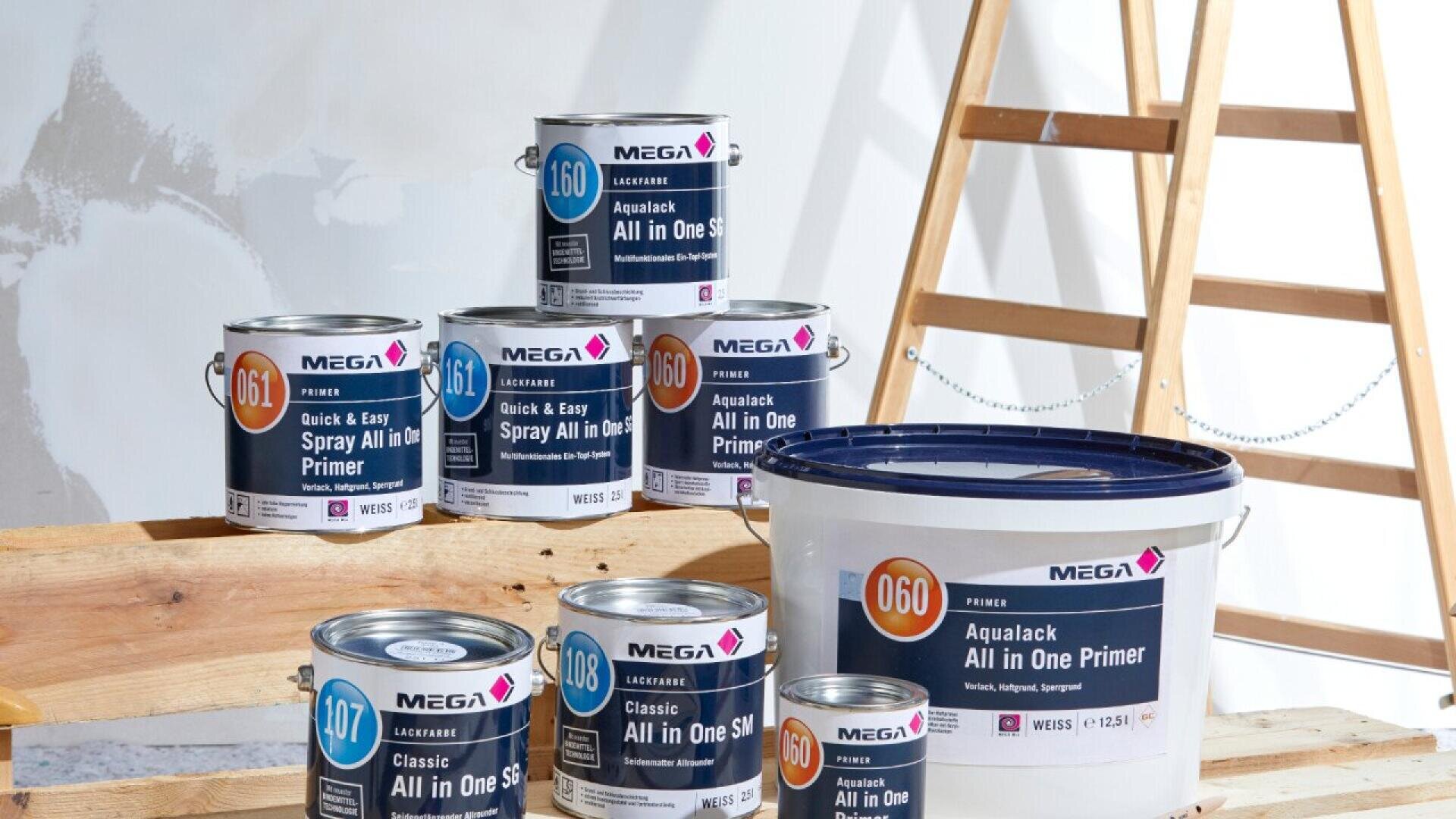 Six cans and one bucket of MEGA Aqualaack All in One Primer are displayed on wooden planks in front of a ladder and a wall with unfinished paint patches. The cans have various labels and color codes.